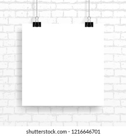 Vector image (mockup, layout) of a square poster, fastened with a black paper clip on a brick wall texture background. Template, frame for your text or image. EPS 10.