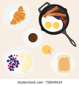 vector image of set of dishes for a traditional Breakfast - frying pan with bacon and eggs, toast with peanut butter, oatmeal with berries and fruit, juice, coffee, croissant. Top view.