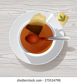 Imagen vectorial de una taza blanca de té en un platillo con una cuchara y bolso de té dentro contra un fondo de madera texturada