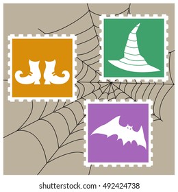 Vector imitation postage stamps with silhouettes as Halloween characters:  bat, witches hat and shoes on the background of spiderweb. 