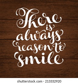 Vector inscription with ornamental elements on wood background. "There is always reason to smile" poster or postcard. Typography collection