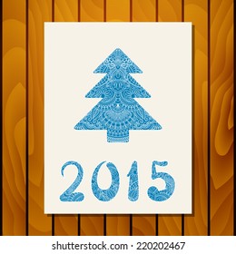 Vector invitation card with christmas tree on wood background.