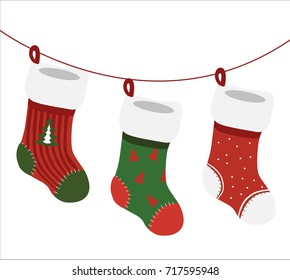 A vector isolated on white background - three empty decorated christmas socks in christmas colors hanging on cord.