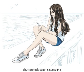 Vector isolated sketchy style drawn illustration of a beautiful young woman with long hair sitting at the sea shore holding smartphone in her hands. Ocean, girl, summer, seaside, top, shoes, shorts