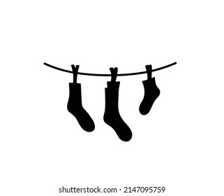 Vector isolated socks hanging on a rope with clothespins symbol outline black colored silhouette shadow