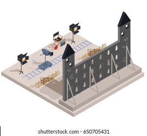 Vector isometric illustration of a film set with a set of filmmaking elements - the scenery of an old castle, a camera, lighting equipment, a director s chair, a loudspeaker, clapper