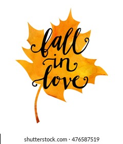 Vector lettering illustration with a maple leaf and a phrase Fall in love. Hand written saying on bright watercolor texture isolated on white background for poster and greeting card design.