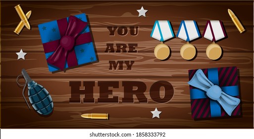 Vector lettering you re my hero. Greeting card for veteran, military, soldier and patriot. Vector illustration with a gift, bullet, order, grenade and stars on a wooden table. The view from the top