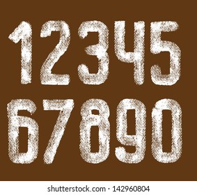 Vector letters and numbers written by white paint on sacking background.