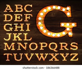 Vector of letters in retro style old lamp alphabet on light board on wood background.