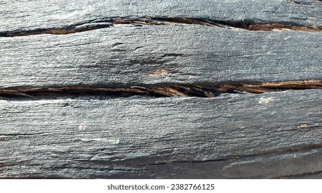 Vector log texture with crack. Old wooden texture of a fence or table in a dark shade. Vector wooden board texture with cracks. Wooden background. Old wooden background.