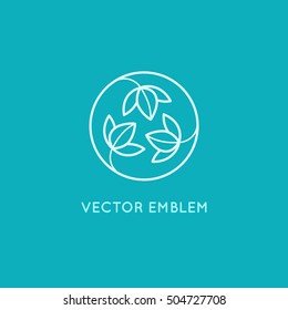 Vector logo design template and emblem made with leaves and flowers - badge for yoga studios, holistic medicine centers, natural cosmetics, handcrafted jewelry and organic food products