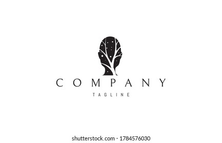 Vector logo on which an abstract image of a human head inside which is a silhouette of a tree.