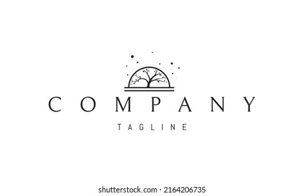 Vector logo on which an abstract image of a large tree against the backdrop of the rising sun.