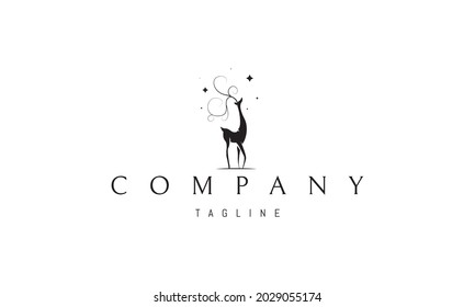 Vector logo in which an abstract image of a graceful deer with antlers in the form of a tree on a background of stars.