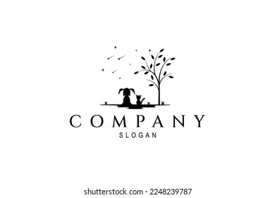 Vector logo which is an abstract image of a little girl sitting with a cat enjoying the view under a tree on a star background