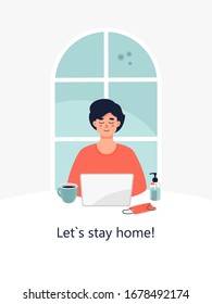 Vector man is working on a laptop at a table near a face mask, sanitizer and cup of coffee at home