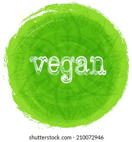 Vector mandala. Green background with leaves. Round ethnic pattern. Inscription vegan. 
