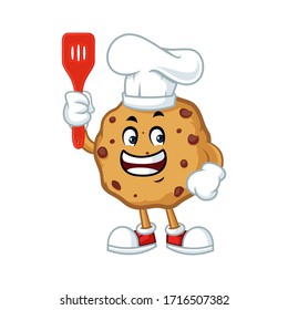 Vector mascot, cartoon, and illustration of a chocolate cookies chips holding spatula
