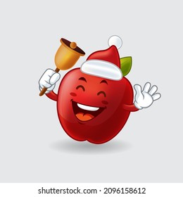 Mascota vectorial, caricatura e ilustración de una manzana roja sosteniendo la campana dorada de Navidad