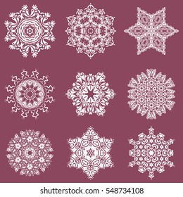 Vector Merry Christmas set of nine snowflakes on a purple background.