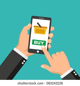 Vector mobile payment concept in flat style - human hand holding mobile phone with shopping basket and buy button on the screen - stock vector