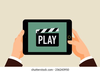 Vector modern flat design background on hands holding tablet computer with multimedia player icon on screen | Clapperboard icon with 'Play' title displayed on mobile computer