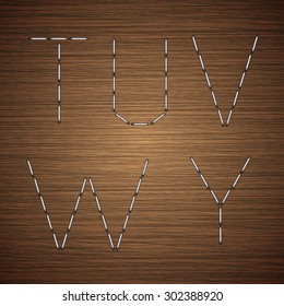 Vector modern staples alphabet on wooden background