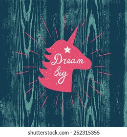 Vector motivation card with unicorn silhouette, sunbursts, and text "Dream big" on the wooden texture. Stylish vintage background with inspirational words.