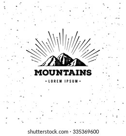Vector mountains emblem. Outdoor activity symbol with grunge texture.
