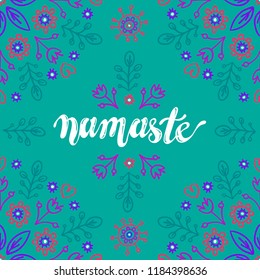 Vector namaste lettering with floral detailes on blue background