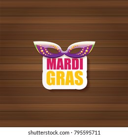 vector new orleans mardi gras carnival label with mask and text on wooden wall background. vector mardi gras party or fat tuesday poster design template with space for text