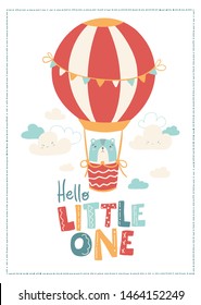 Vector nursery banner with cute animal - bear in a balloon in the clouds. The illustration is in simple Scandinavian style. Lettering - hello little one