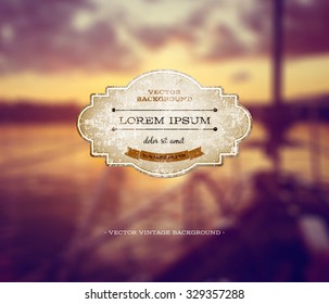 Vector old weathered vintage paper label over a retro photographic blurred bokeh background