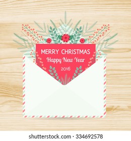Vector open envelope and greeting card Merry Christmas and Happy New Year 2016 with fir tree branches christmas and berries on a wood texture background