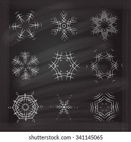 Vector ornamental snowflakes set on chalkboard background.