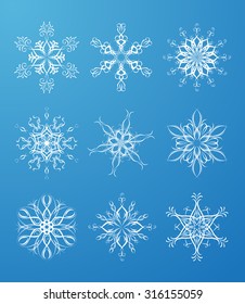 Vector ornate snowflakes set. Nine various vintage snowflakes for your Christmas design. White snowflakes on blue winter background for your design. 