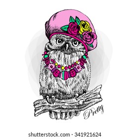Vector owl in a pink hat. Bird with necklace. Owlet on a tree branch.

