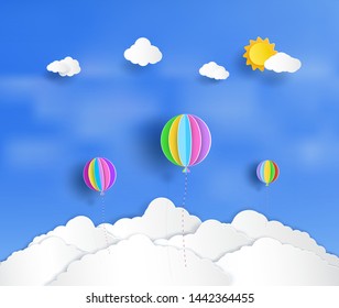 Vector paper cut. And there is a beautiful and colorful balloons floating above the clouds.And natural bright.And origami style design.and an illustration or background. 
