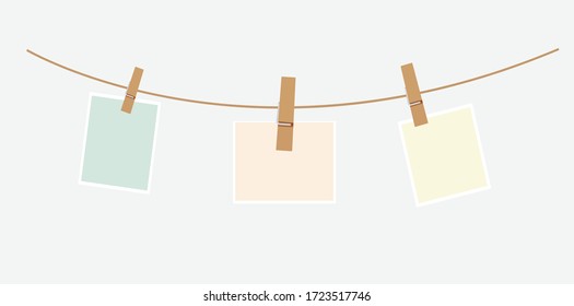 vector pastel green orange yellow colour paper notes and clothespins hang on a brown rope with gray background.