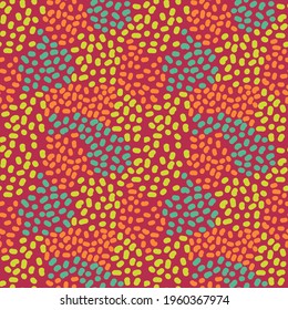 Vector pattern with bright specks on an orange background. Seamless pattern with green, orange and variegated polka dots for printing on children's textiles.
