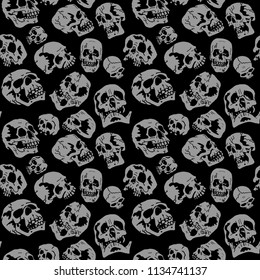 Vector Pattern. Gray skulls on a black background. Sketch
