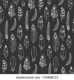 Vector pattern with hand drawn feathers on the black background.