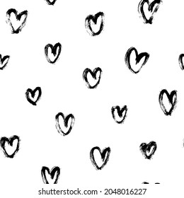 Vector pattern with hand-drawn black hearts. Polka dot ornament. Linear silhouettes of charcoal hearts. Black-white seamless pattern for Valentine's Day. Simple repeating chaotic texture.