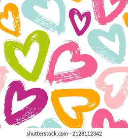 Vector pattern with hand-drawn brush strokes hearts. Seamless background in bright colors.