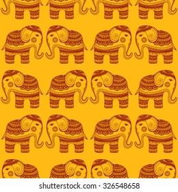 Vector pattern with indian elephants. Hand drawn doodle elephants with tribal ornament. Yellow and red colors. Seamless background.
