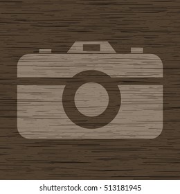 Vector photo camera icon. Minimalistic illustration on wooden background.