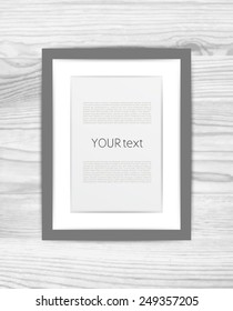 Vector photo picture frame with place for text on a white wood background