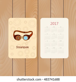 Vector pocket calendar for 2017 with steampunk glasses with metal elements in doodle style