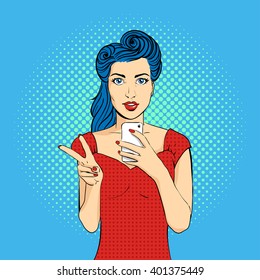 Vector pop art woman face with open mouth holding a phone in her hands. Victory gesture. Retro style.